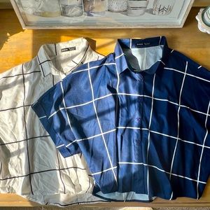 Two short sleeve collared shirts, navy and white